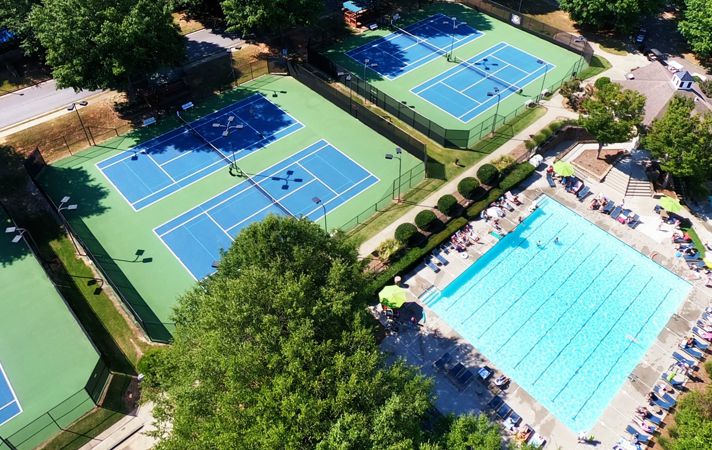 Drone photography of neighborhood pool and tennis courts for Polo Golf and Country Club.